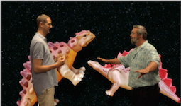 robert and drew in front of a dinosaur background